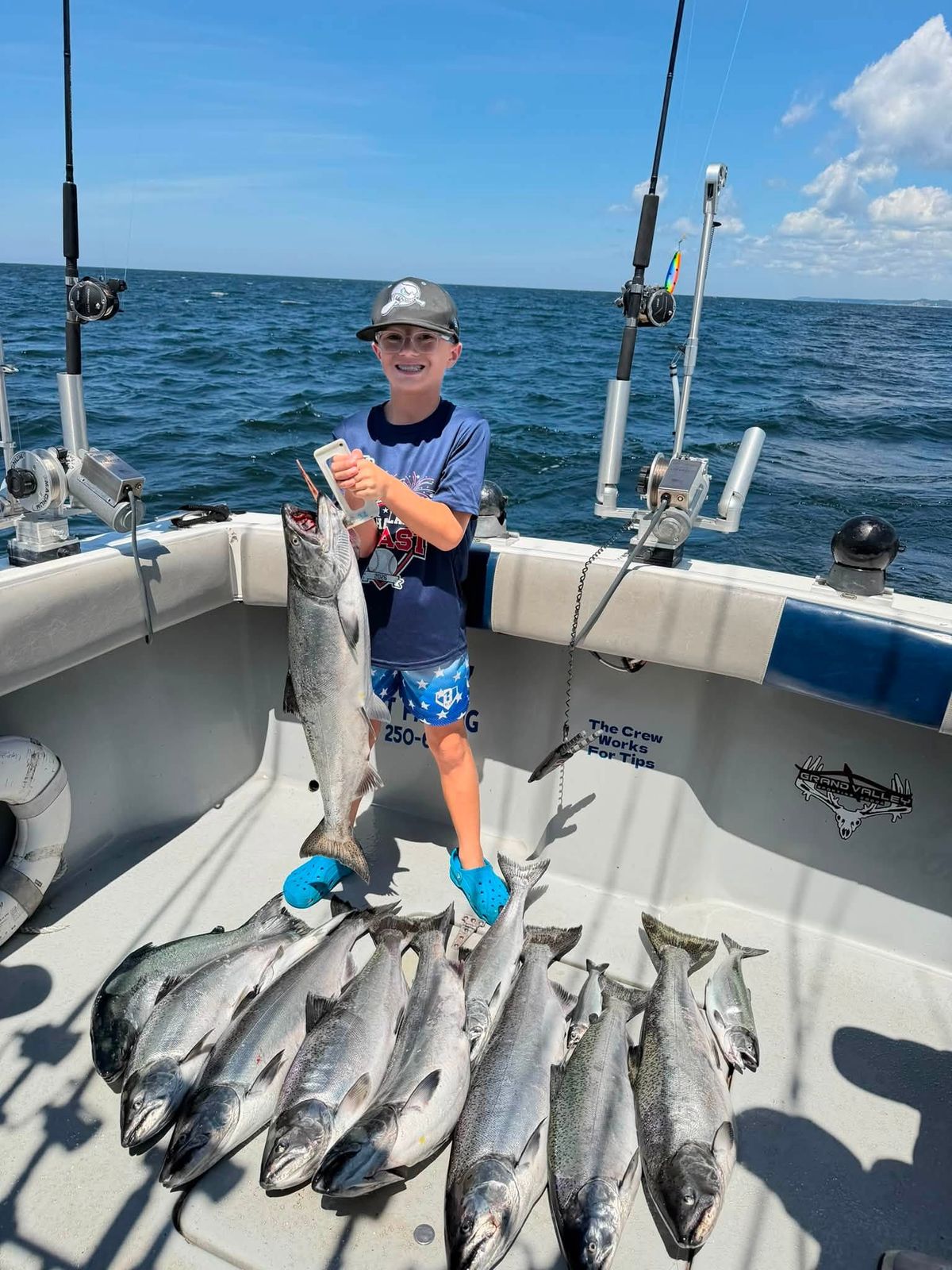 A young angler displays a large catch of fish aboard the charter boat