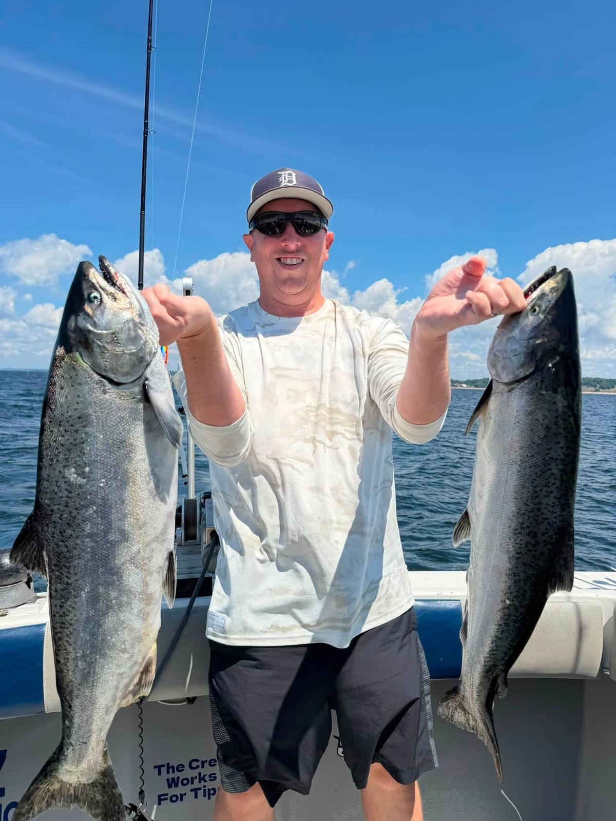 Captain Anthony Sova holds two large Lake Michigan salmon