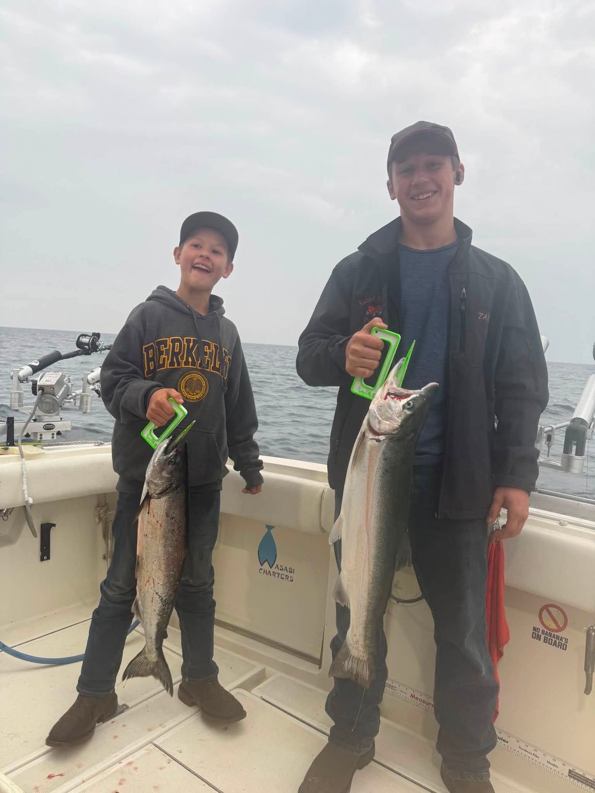 Captain Anthony Sova and a young angler with their catch on the deck of the charter boat