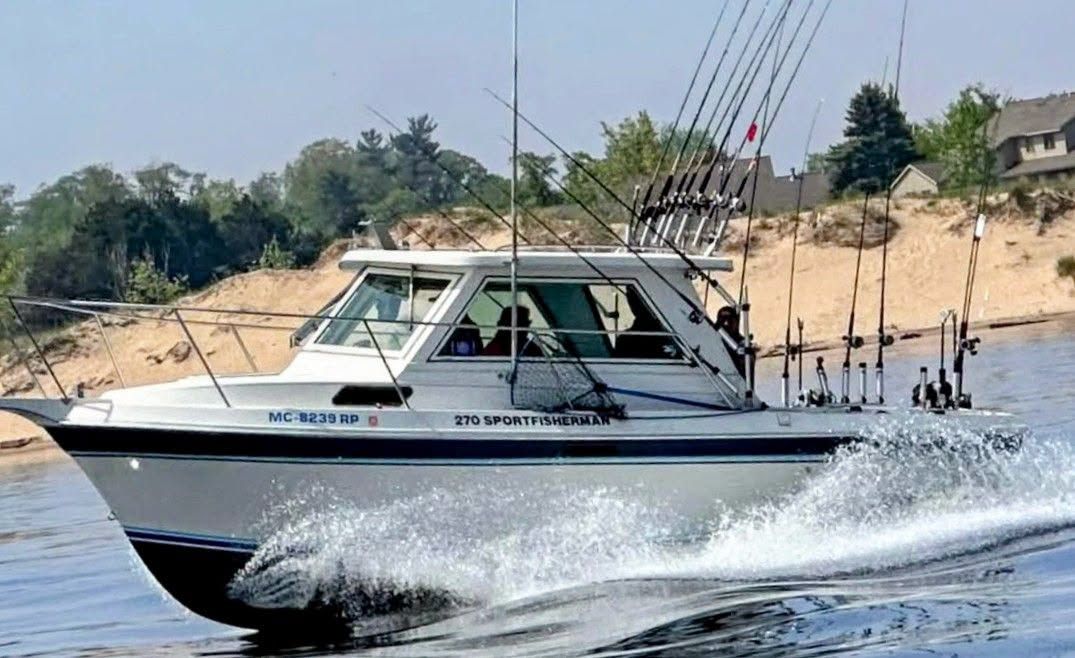 The Too Ez 27-foot Cherokee charter boat with multiple rod holders, operating on Lake Michigan